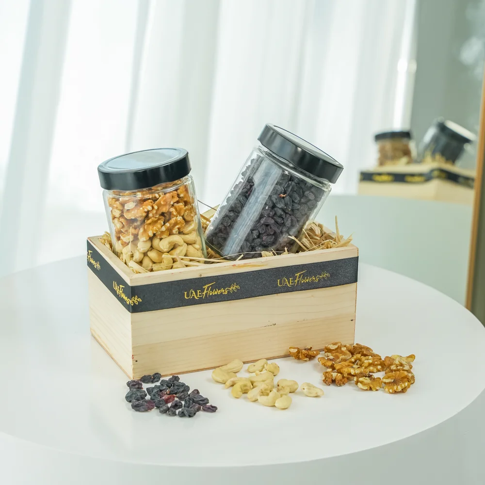 Sets of Mixed cashew & walnuts and black raisins in a wooden tray.