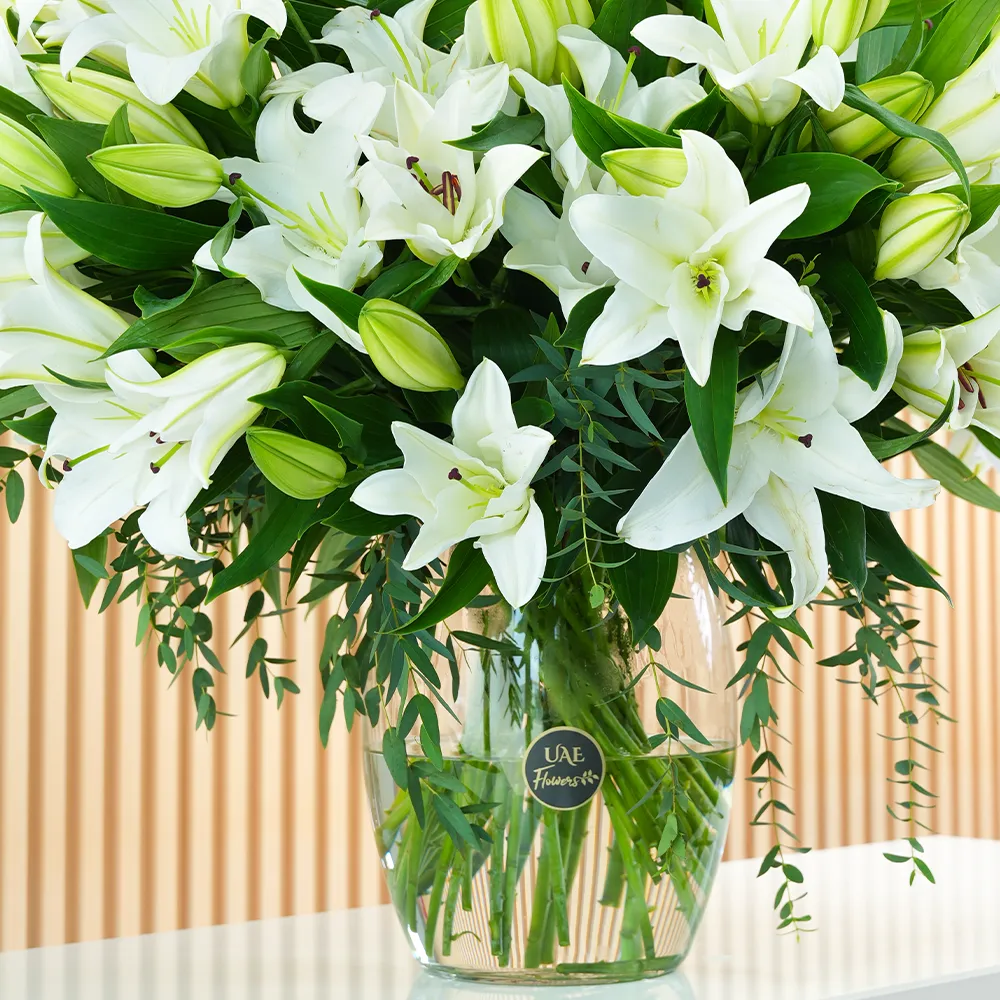glass vase with 20 white lilies and green fillers