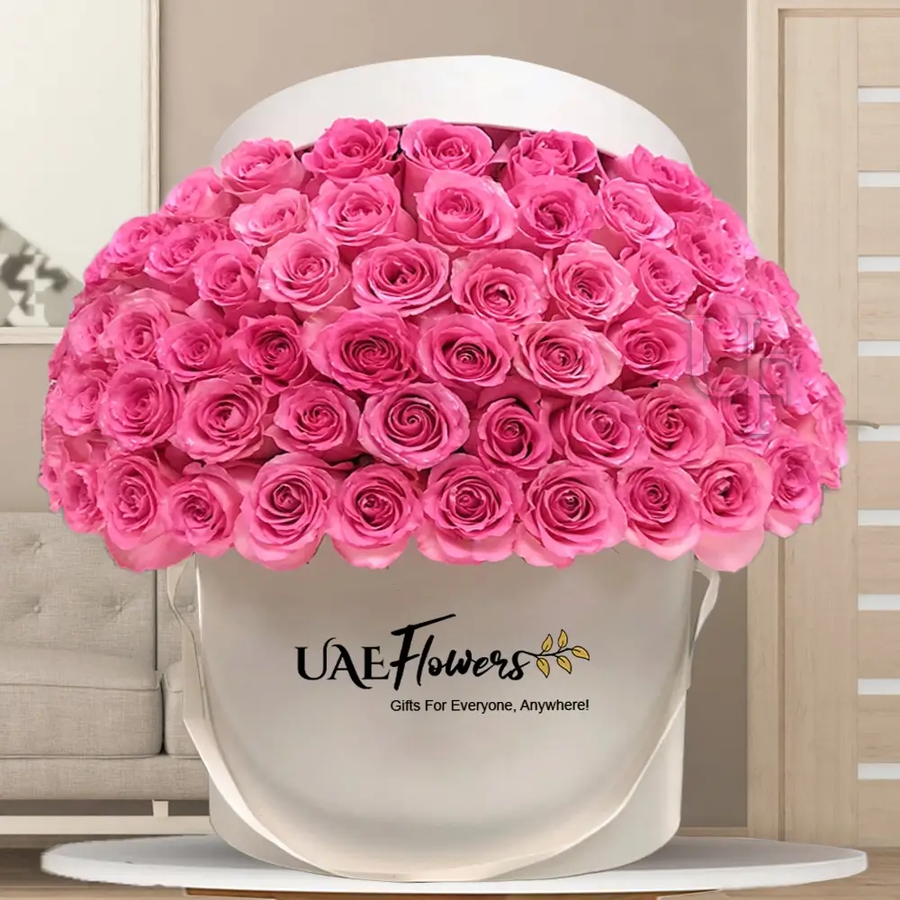 60 pink roses arranged in a white round hatbox