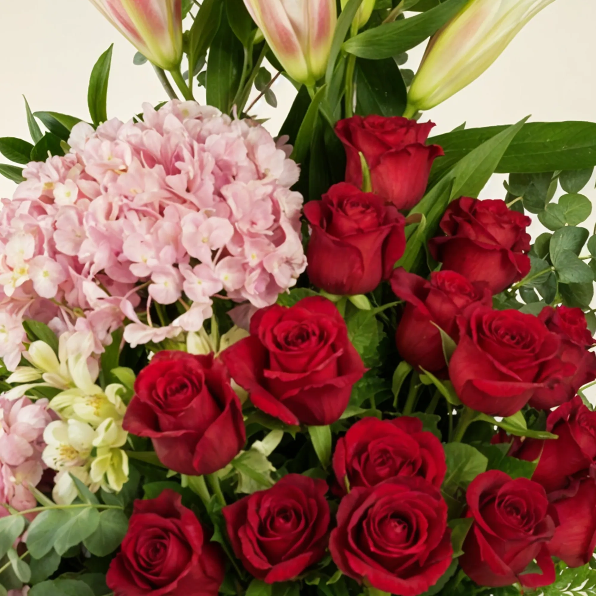 2 pink hydrangeas, 2 pink lilies, 2 white alstroemerias, 15 red roses