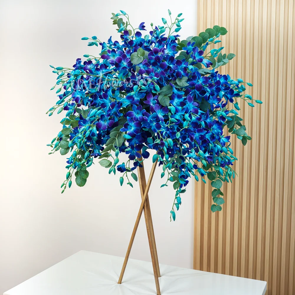 50 blue orchids arranged on a stand with elegant fillers.
