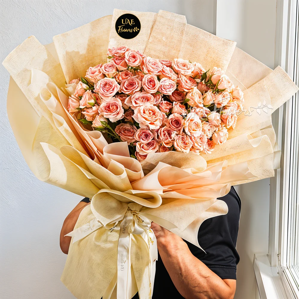 Pink spray 20 roses arranged in pink wrapping and tied with a ribbon