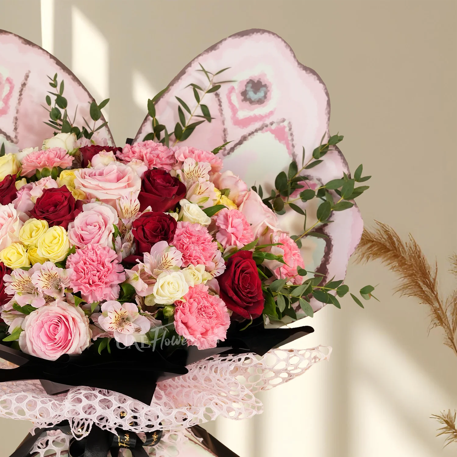 7 red roses, 5 pink roses, 8 pink carnations, 2 pink, 2 white, 2 yellow spray roses, 3 pink alstroemerias