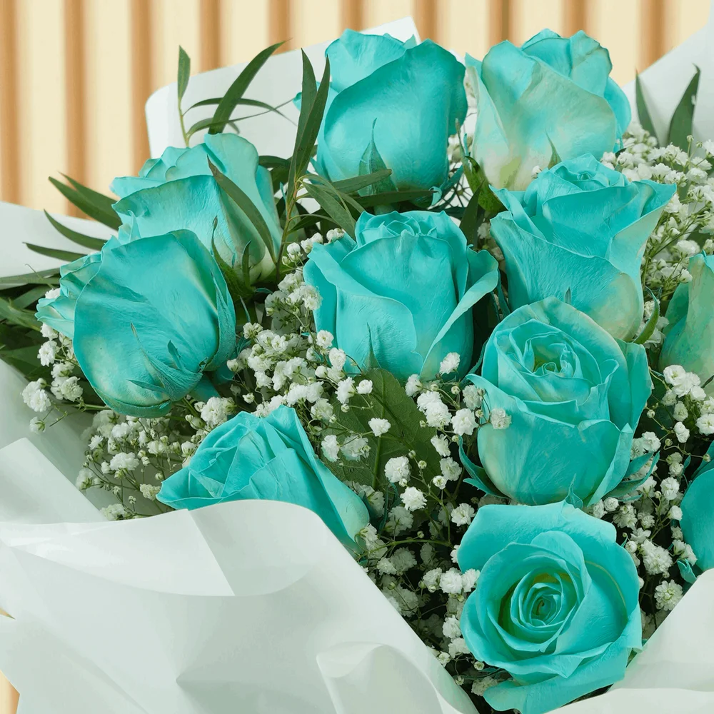 bouquet of 12 vivid blue roses wrapped with care and tied with ribbons