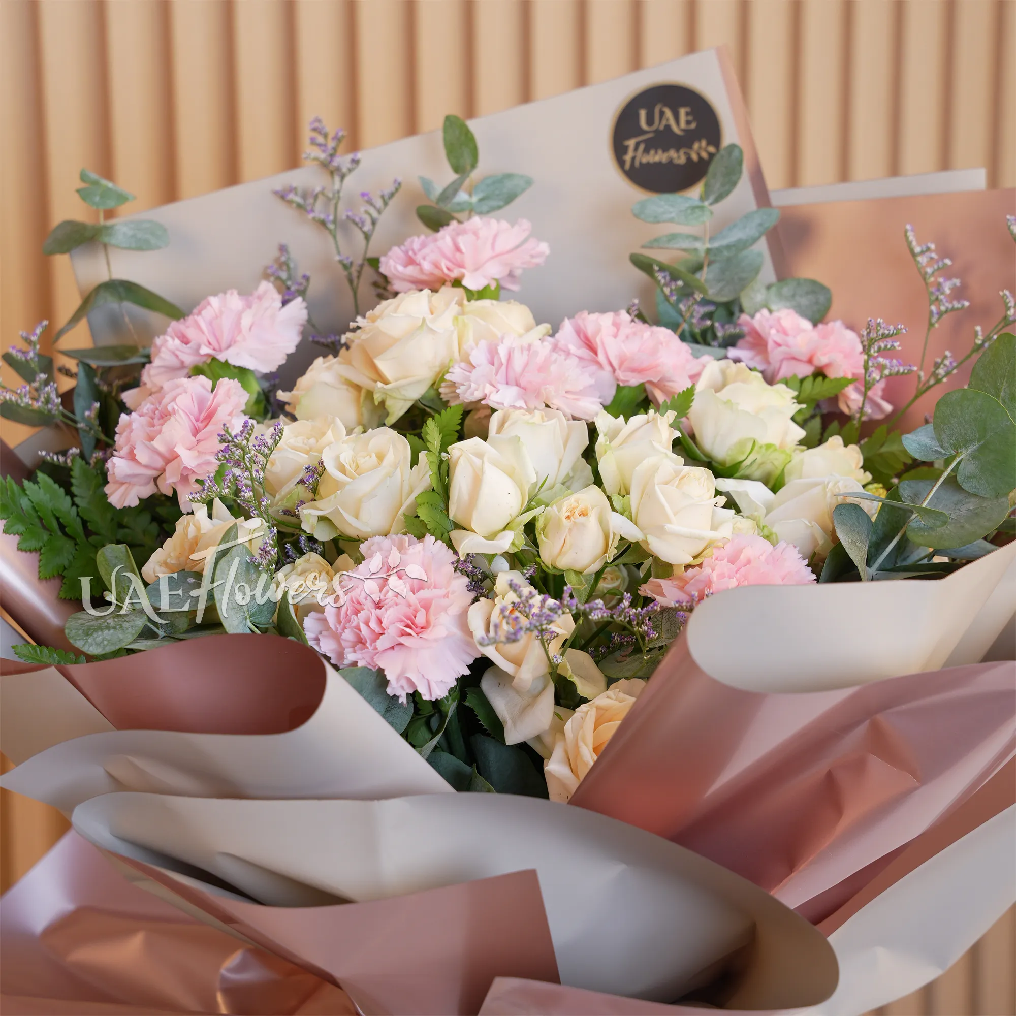 bouquet with 8 soft pink carnations and 5 peach spray roses