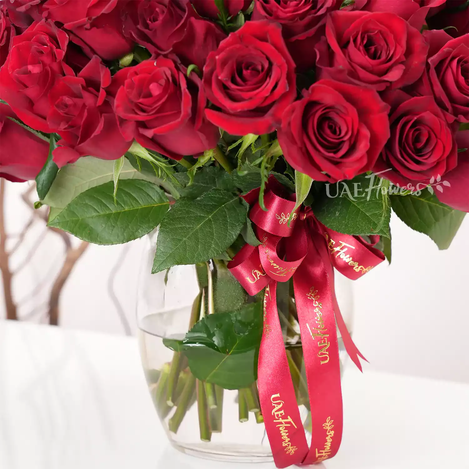 vase arrangement of 40 red roses with green fillers