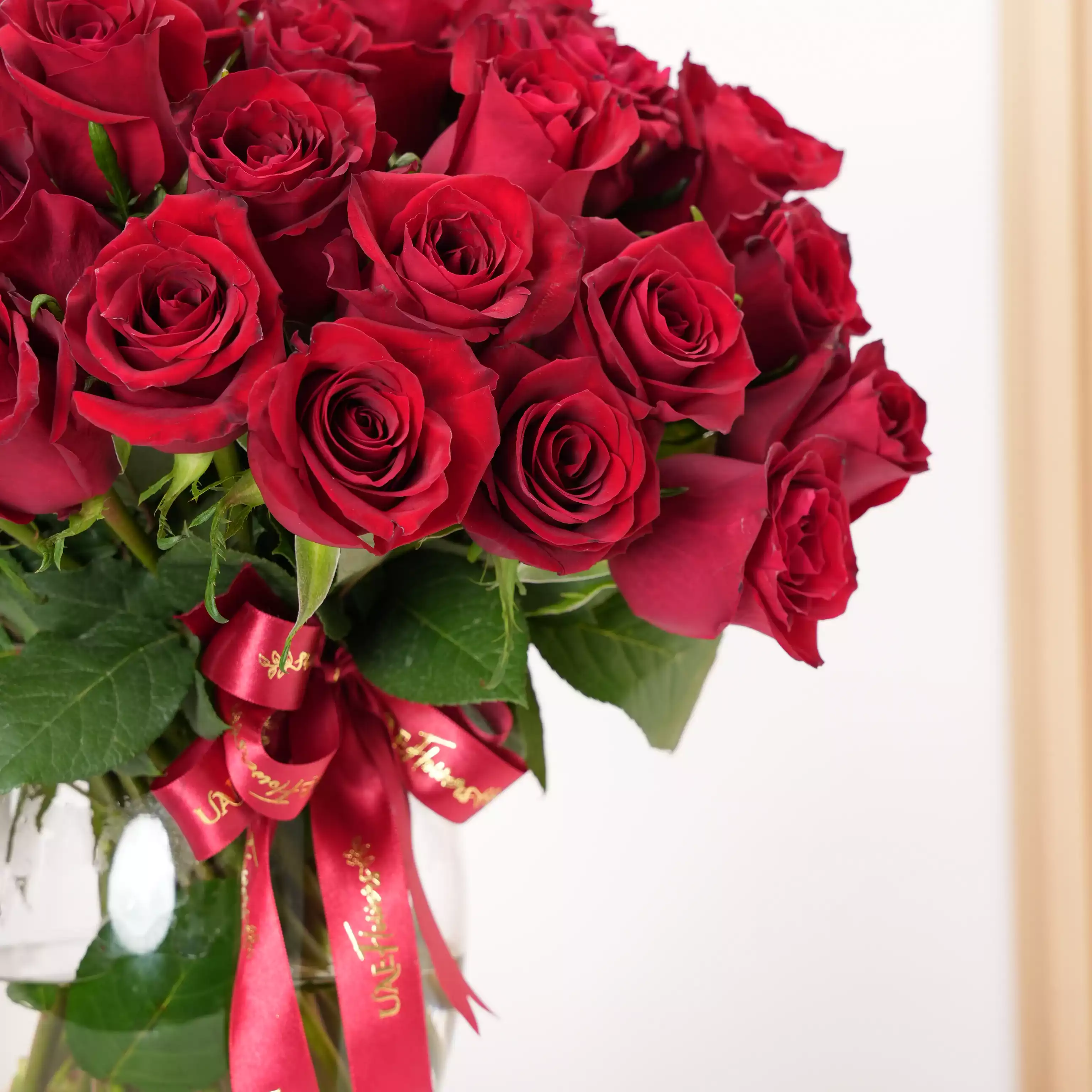 vase arrangement of 40 red roses with green fillers