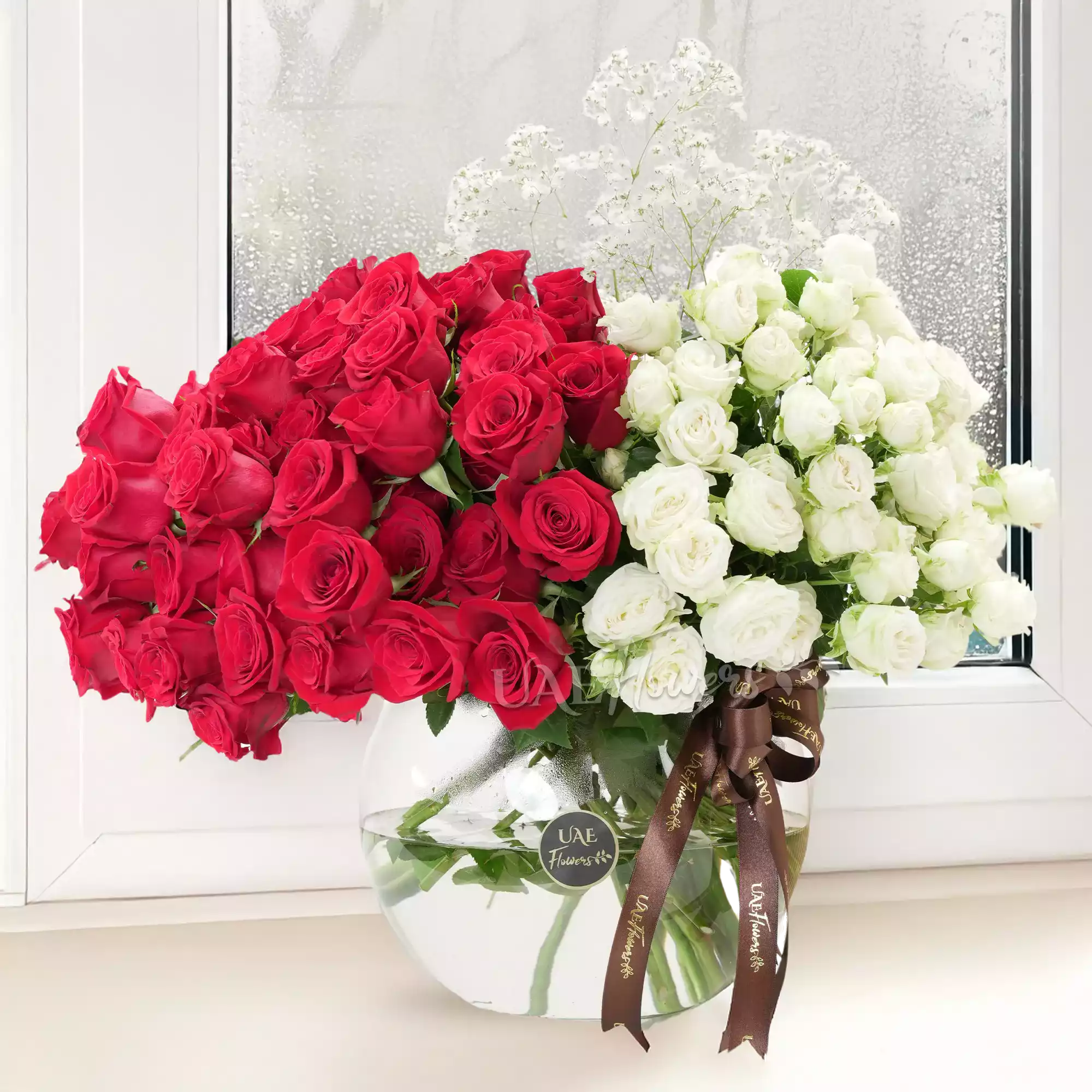 vase of 40 red roses and 10 white spray roses with baby's breath