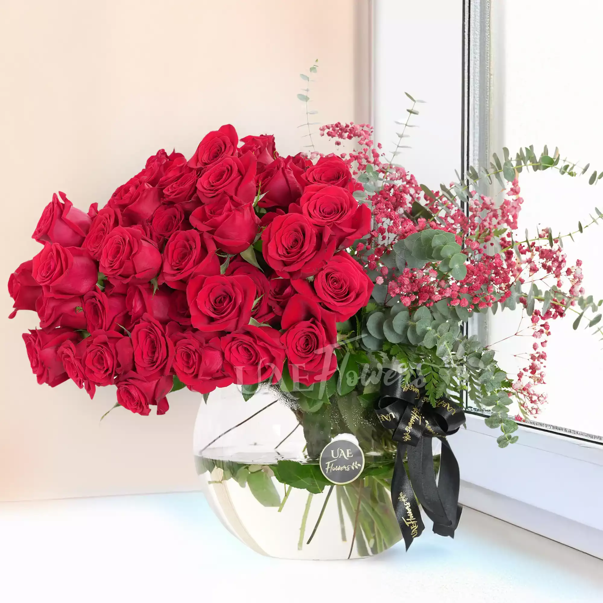 red roses, eucalyptus, and red baby's breath