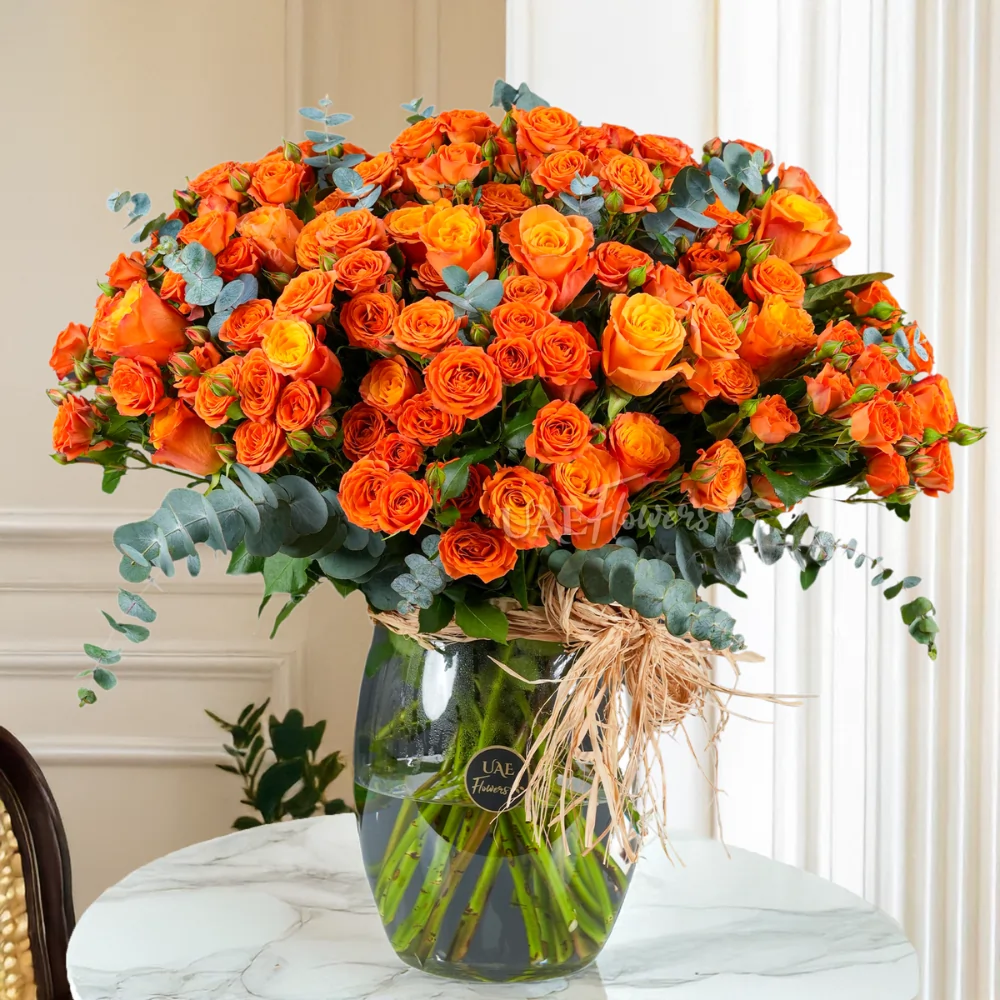 Glass vase with 20 spray roses, 20 classic roses, and green fillers