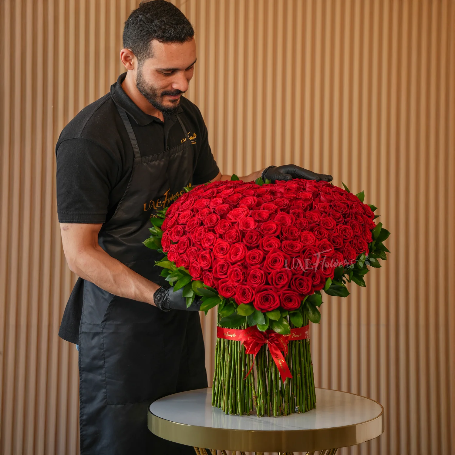 heart-shaped standing arrangement with 120 red roses