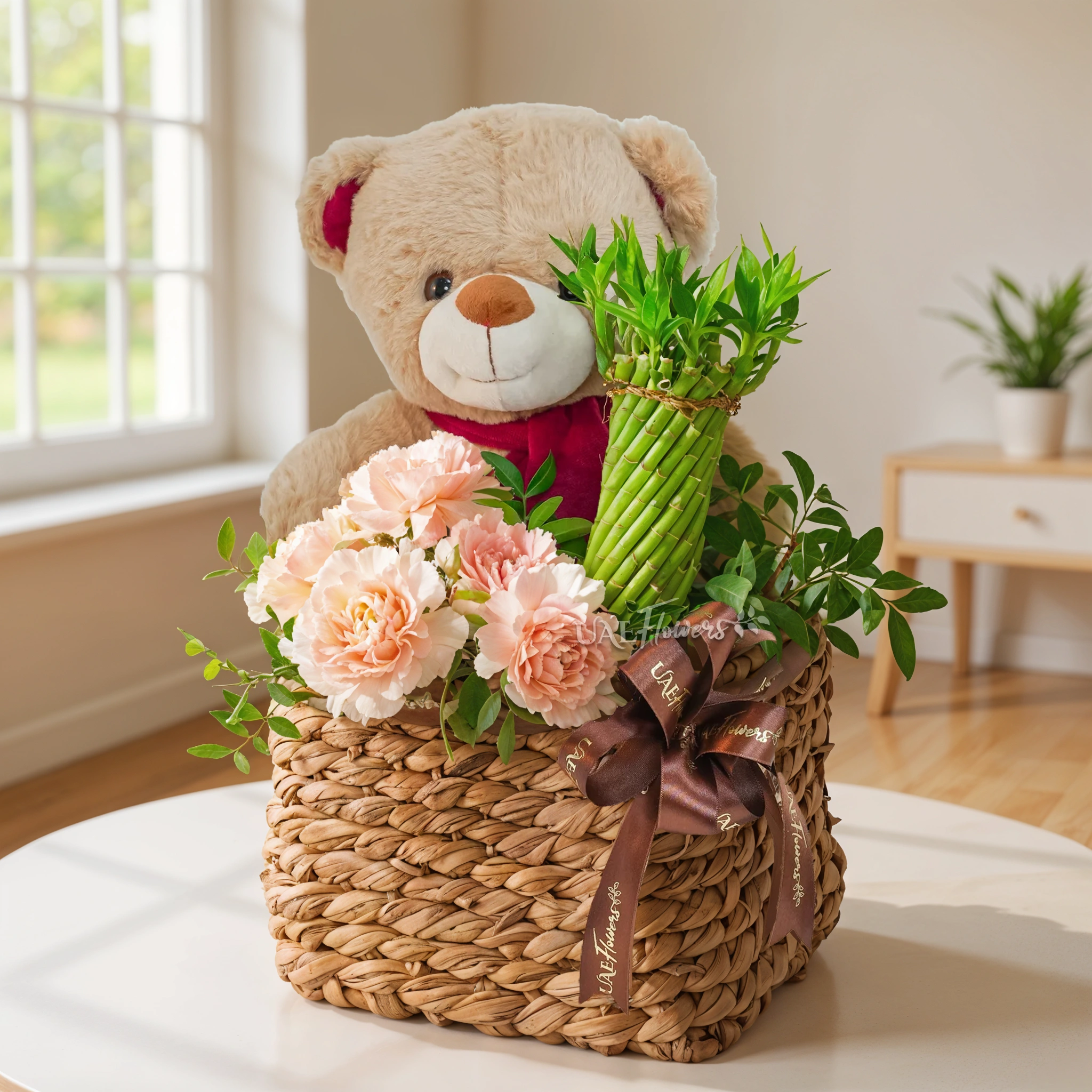 5 pink carnations, a brown teddy bear and a Lucky Wheel Bamboo plant