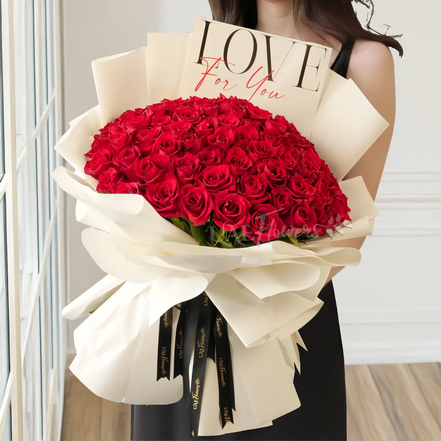 100 red roses in white paper packing