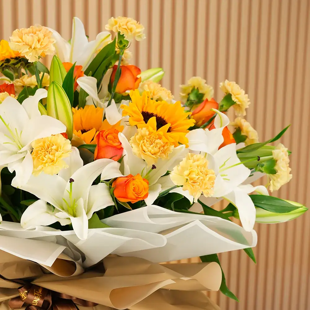 5 white lilies, 5 sunflowers, 10 orange roses, and 15 peach carnations