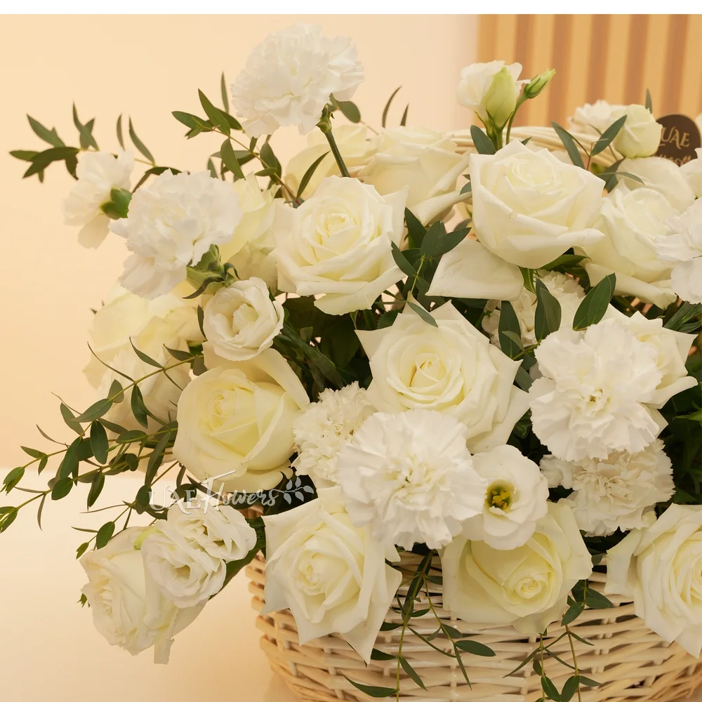 basket arrangement of 15 white carnations and 15 white roses and fillers